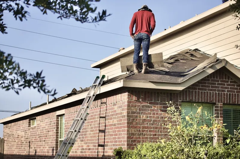Professional roofer working on a residential roof in Country Wood Estates